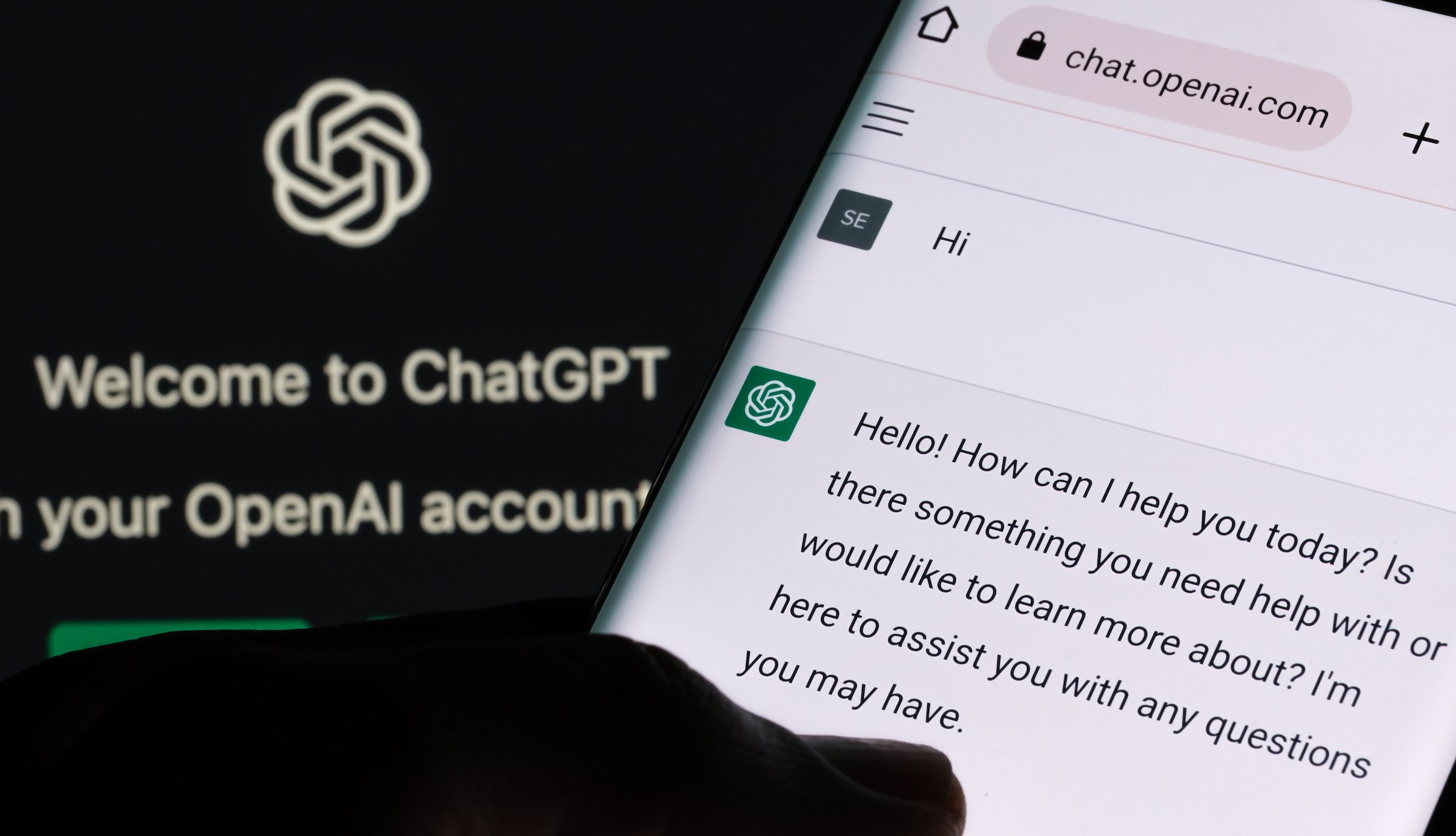 ChatGPT chat bot screen seen on smartphone and laptop display with Chat GPT login screen on the background.